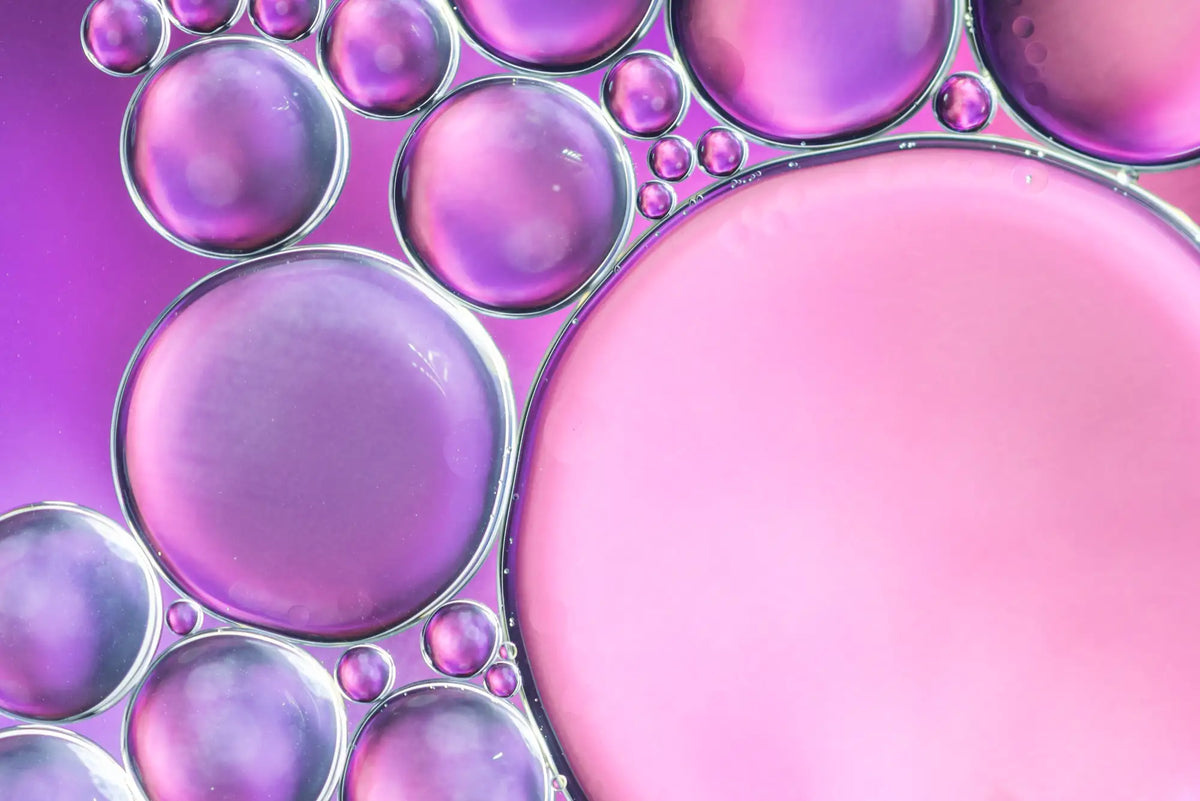 Macro of translucent pink and violet oil bubbles
