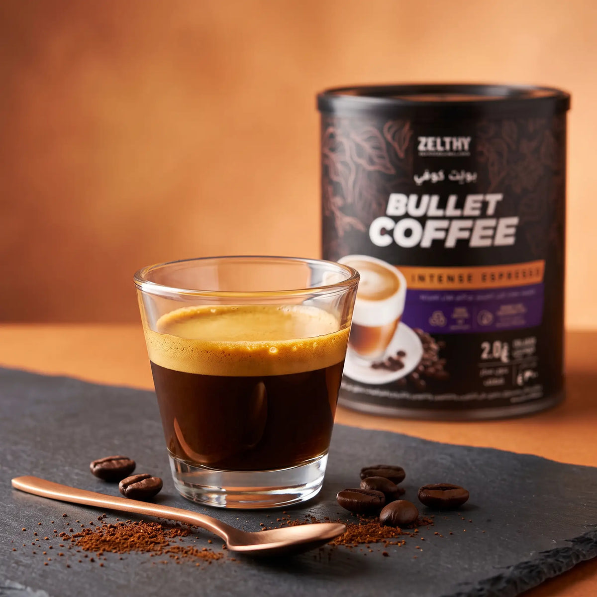 A glass of dark coffee with golden crema beside a tin of Zelthy Bullet Coffee Intense Espresso