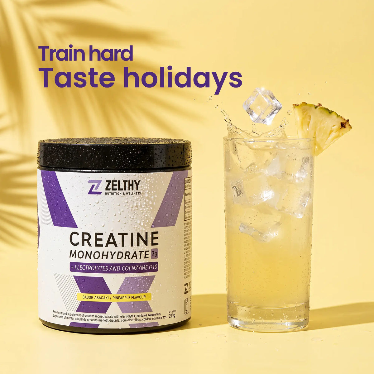 Zelthy creatine with electrolytes and CoQ10 next to an iced pineapple-flavoured drink